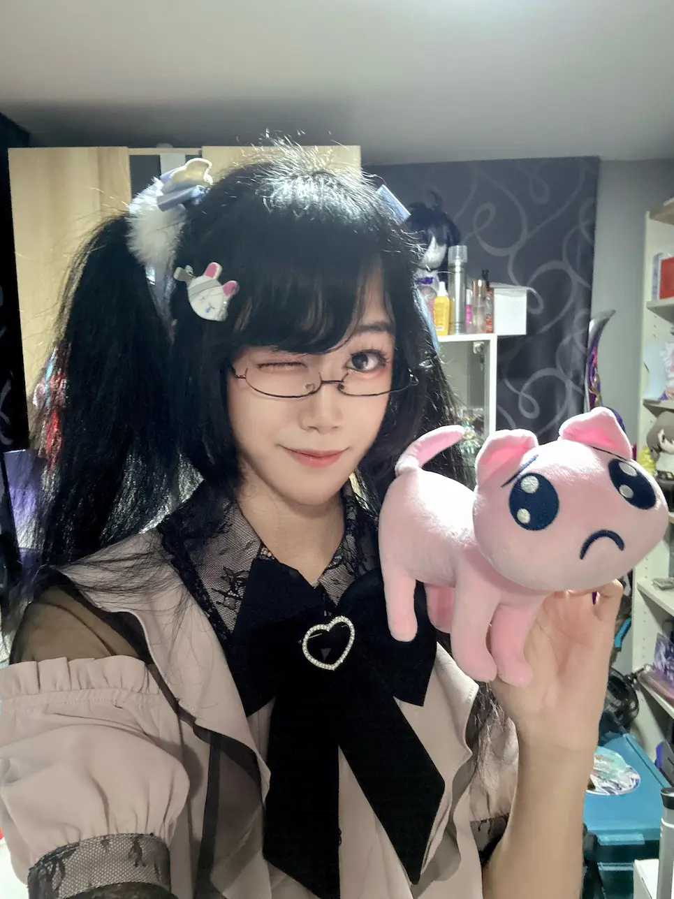 SaltyAom holding a pink pien cat plushie (p-chan)
